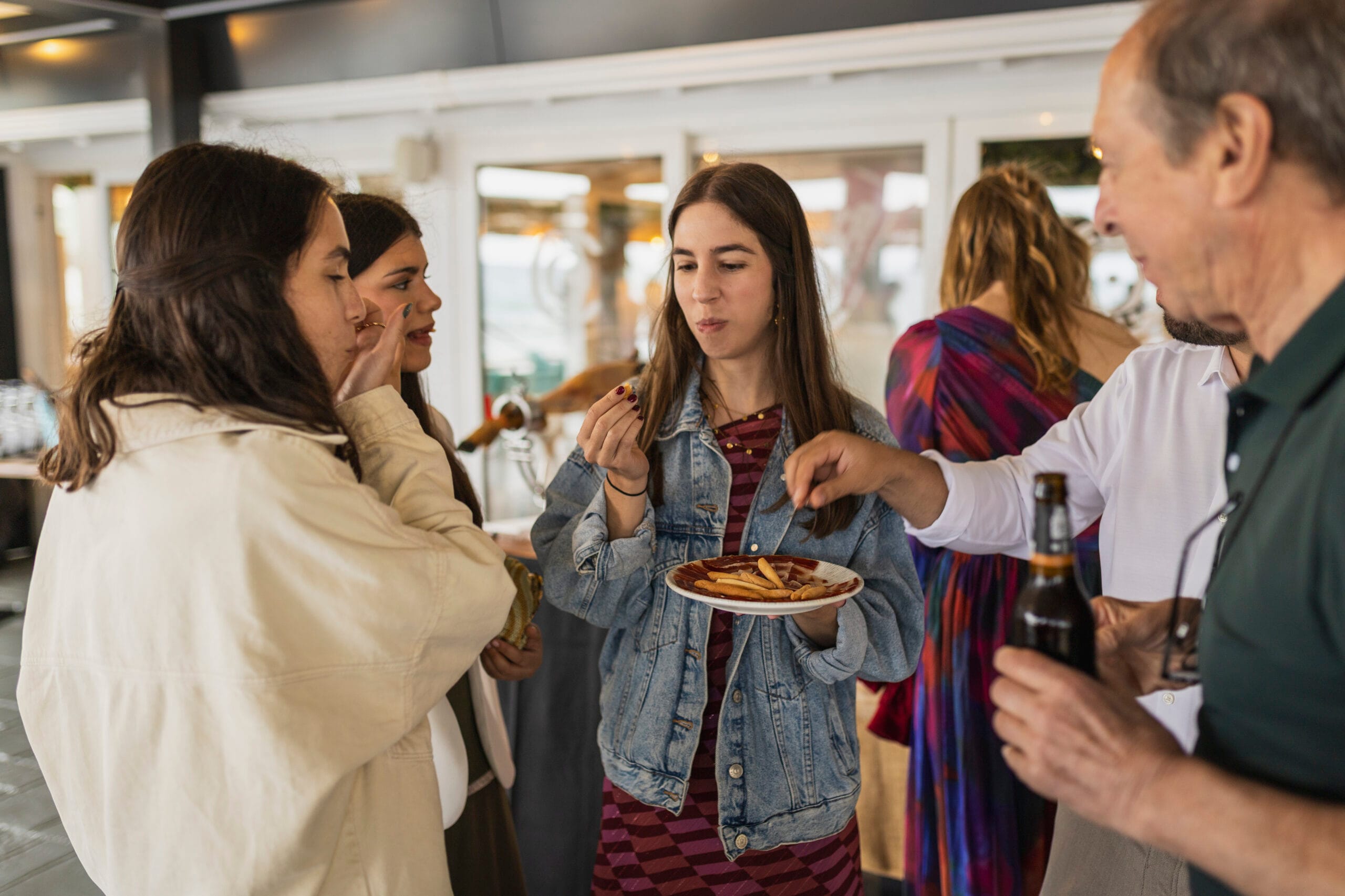 Invitados disfrutando de un plato de jamón ibérico y aperitivos durante un evento privado en Restaurante Escondida.